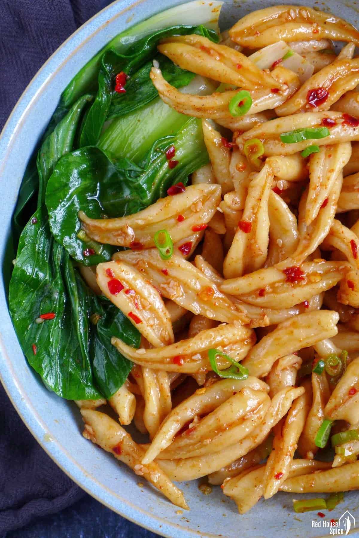 Scissor cut noodles with hot dressing.