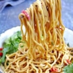 Pulling up Chinese sesame noodles with chopsticks.