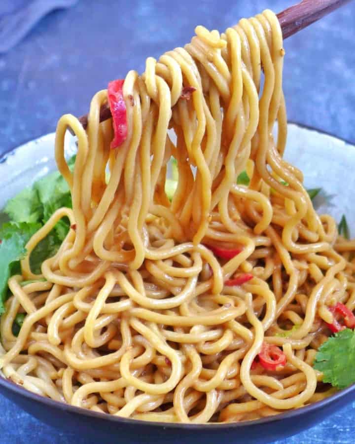 Pulling up Chinese sesame noodles with chopsticks.