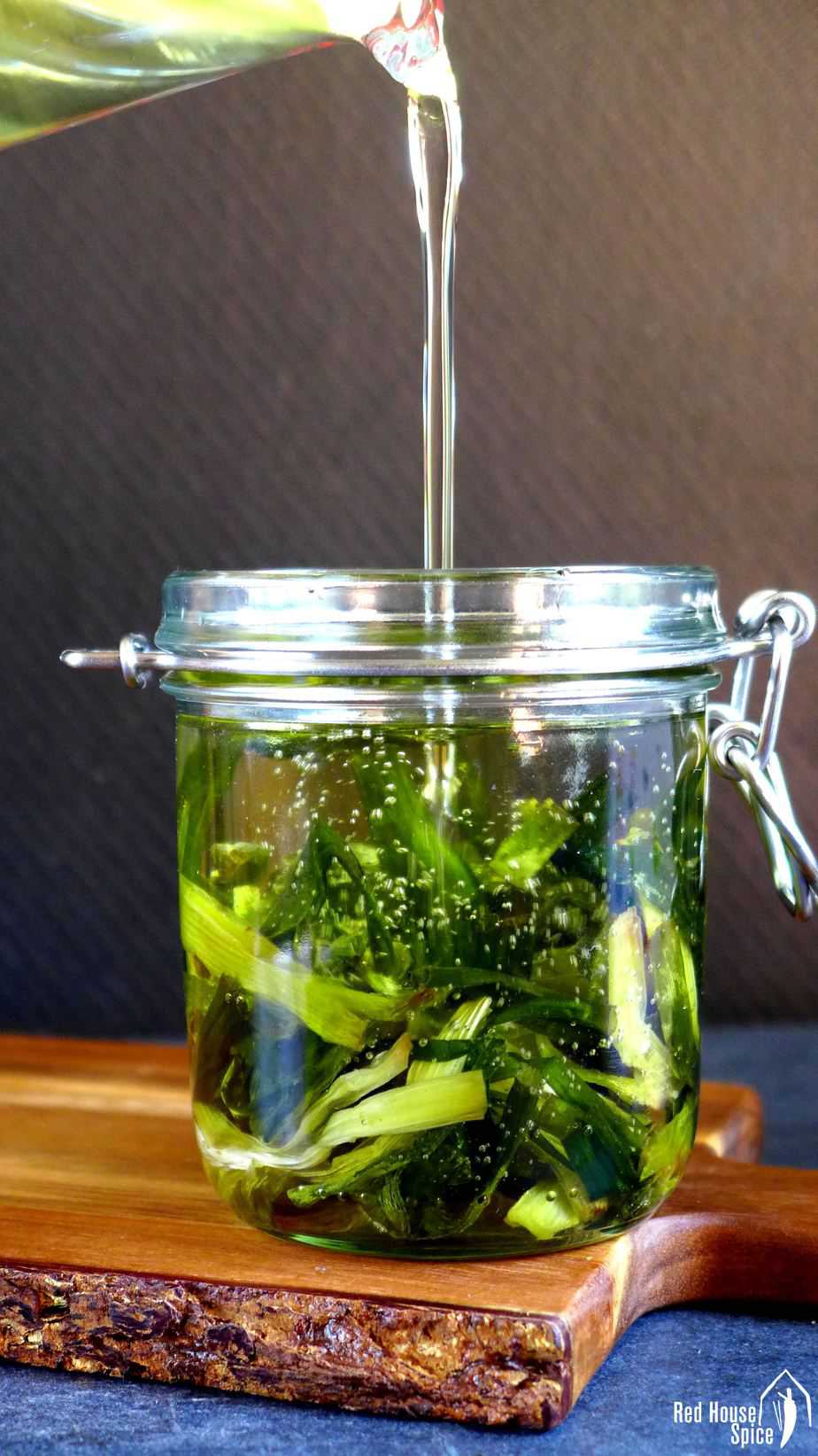 Spring onion oil pouring into a jar