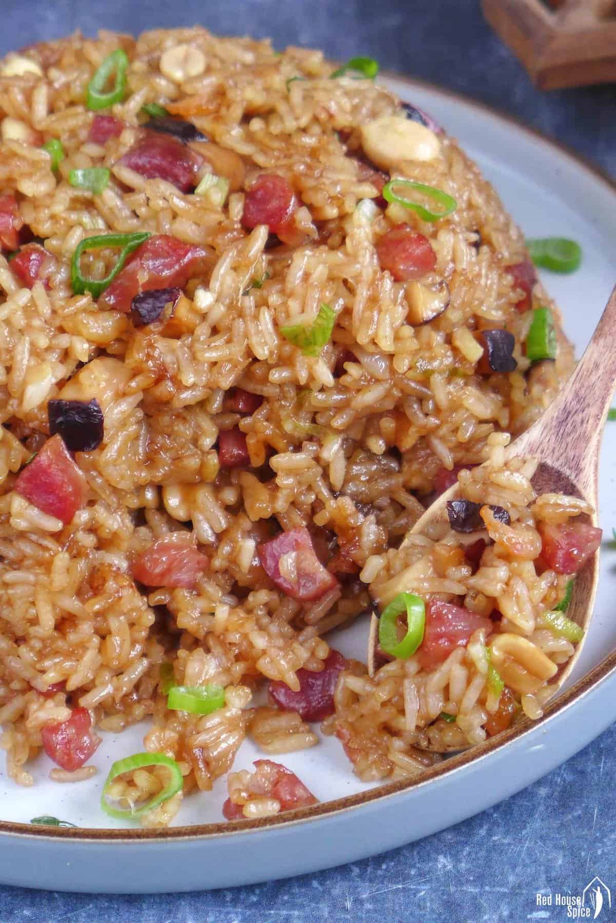 spooning stir-fried Chinese sticky rice.