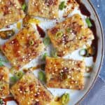 Pan fried turnip cake with soy sauce and chili oil