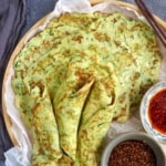 zucchini pancakes on a tray with sauces.