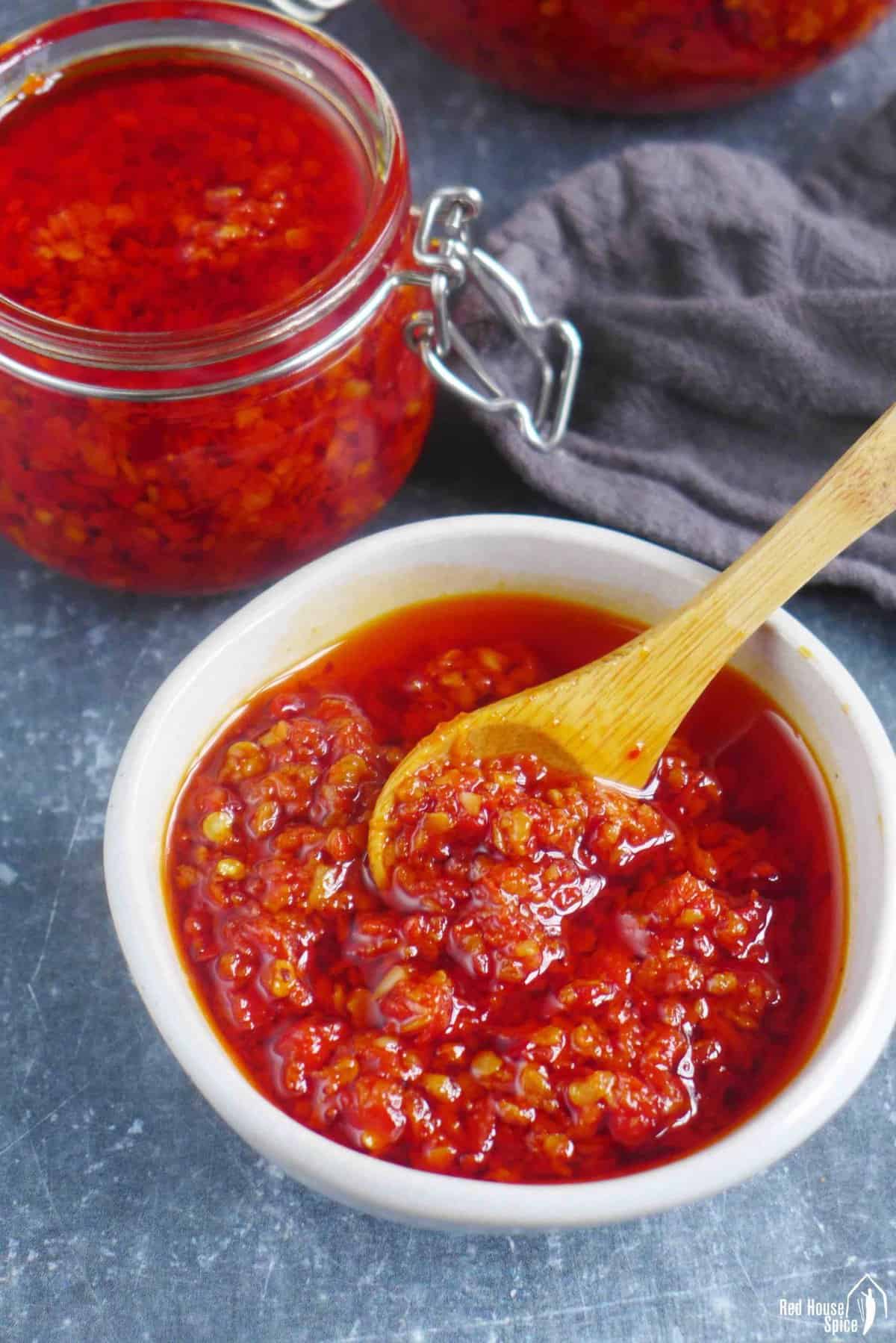 chiu chow chili oil in a bowl and in jars.