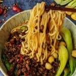 Chongqing noodles lifted up by a pair of chopsticks.