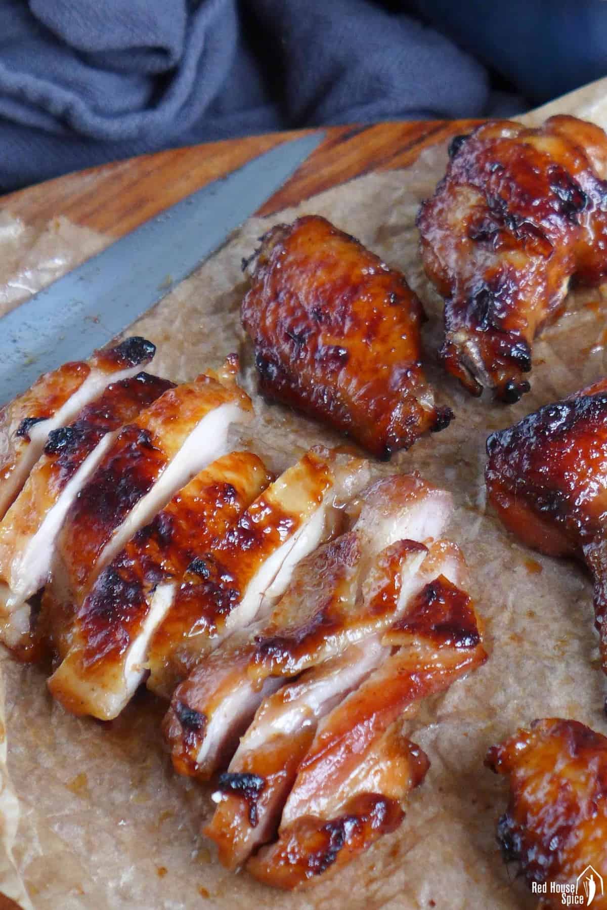 Char Siu chicken wings and sliced Char Siu chicken thighs on a chopping board