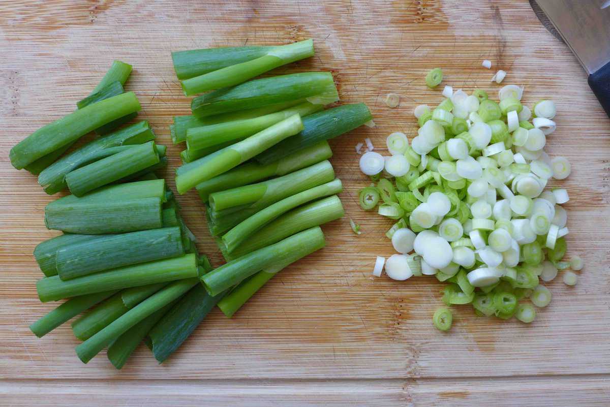 chopped scallions on a chopping board.