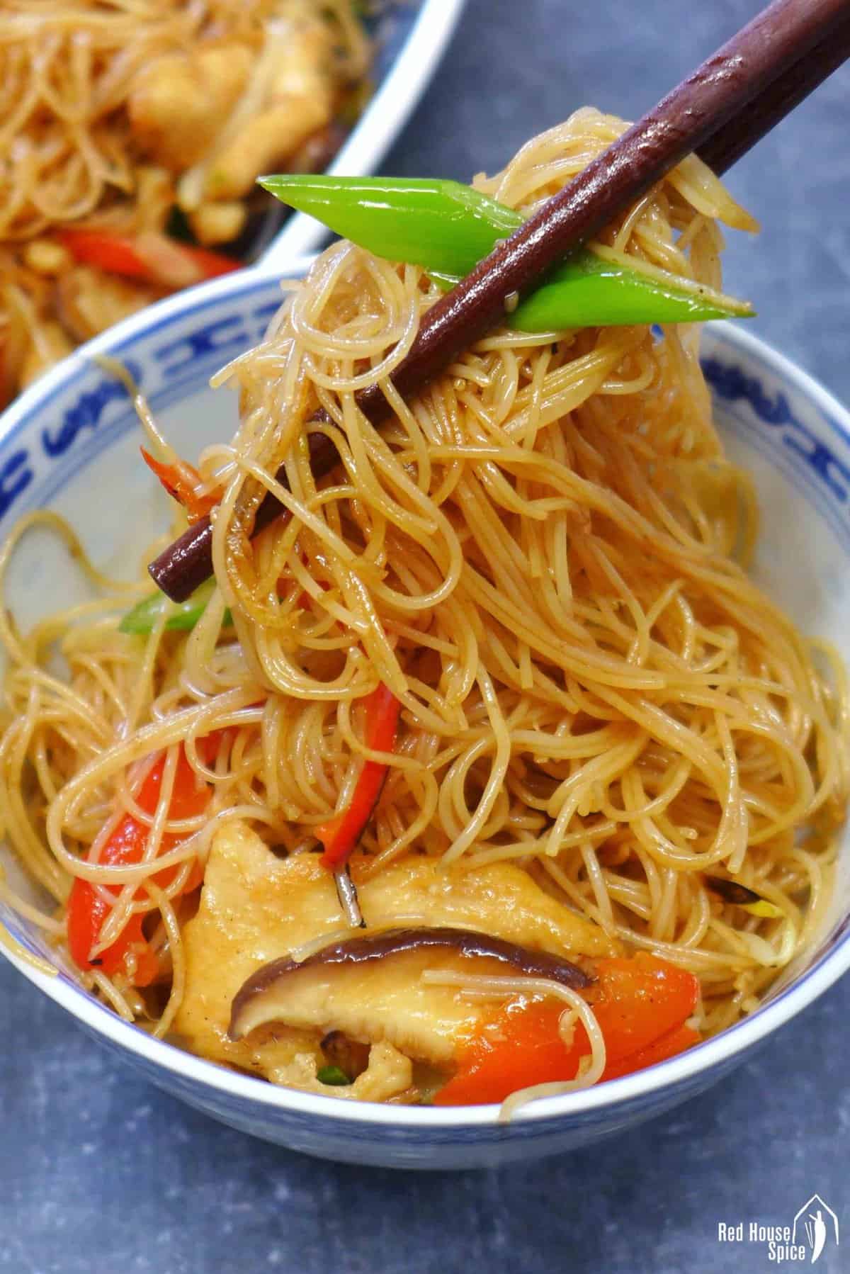 chow mei fun picked up by chopsticks.