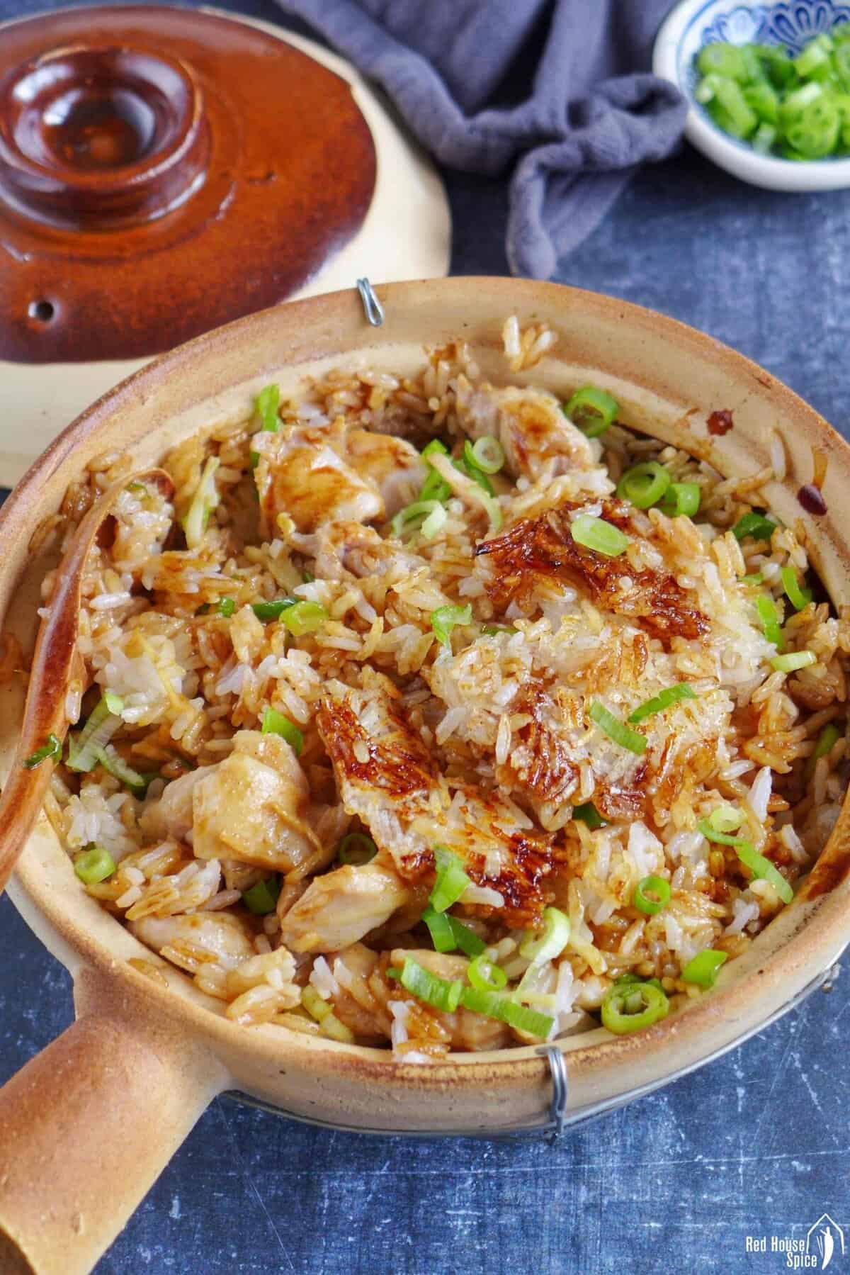 scorched rice and chicken in a clay pot.