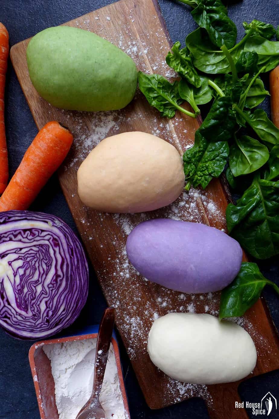 Four pieces of dumpling dough naturally dyed into different colours.