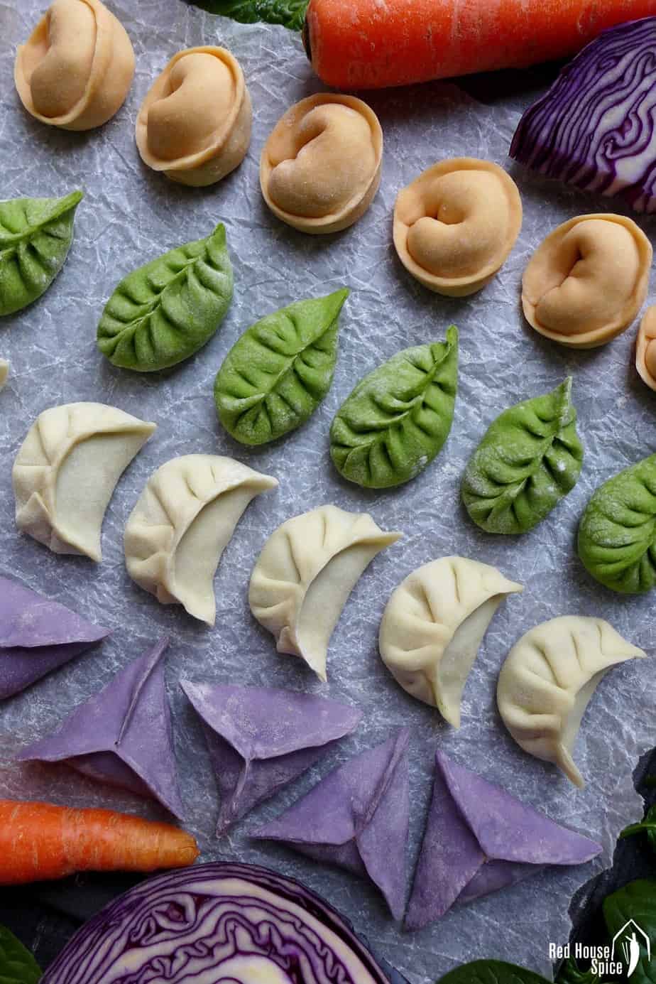 Chinese dumplings in four colours and four shapes.