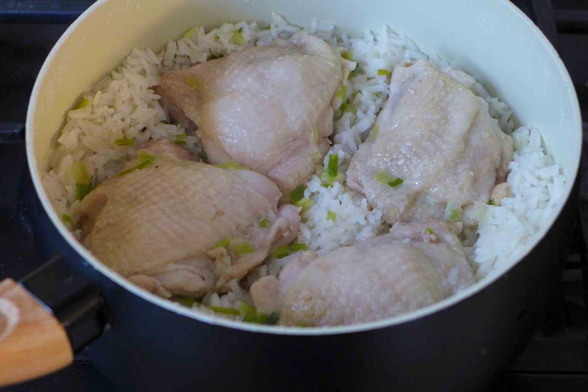 cooked chicken thighs and rice in a pot