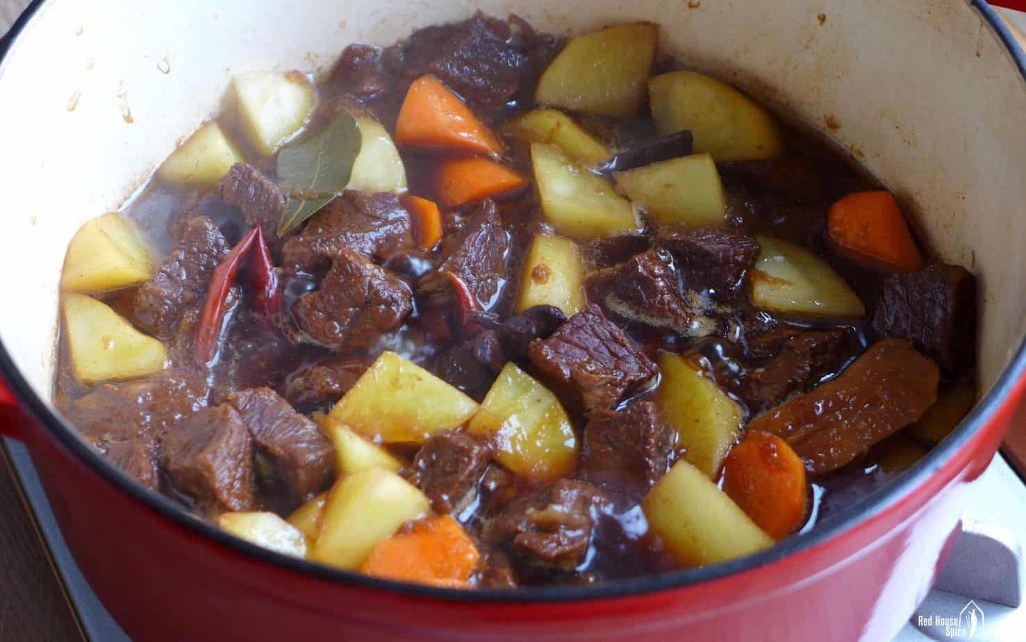 cooking beef and potato in a pot