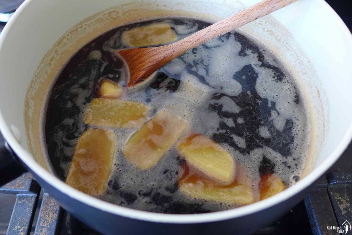 cooking dark brown sugar and ginger in water.