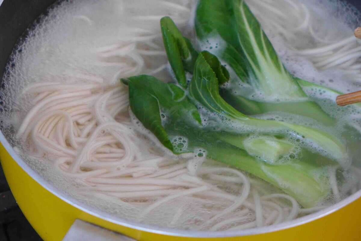boiling noodles and bok choy.