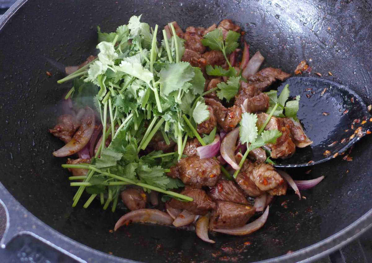 cilantro over stir-fried lamb and onion.