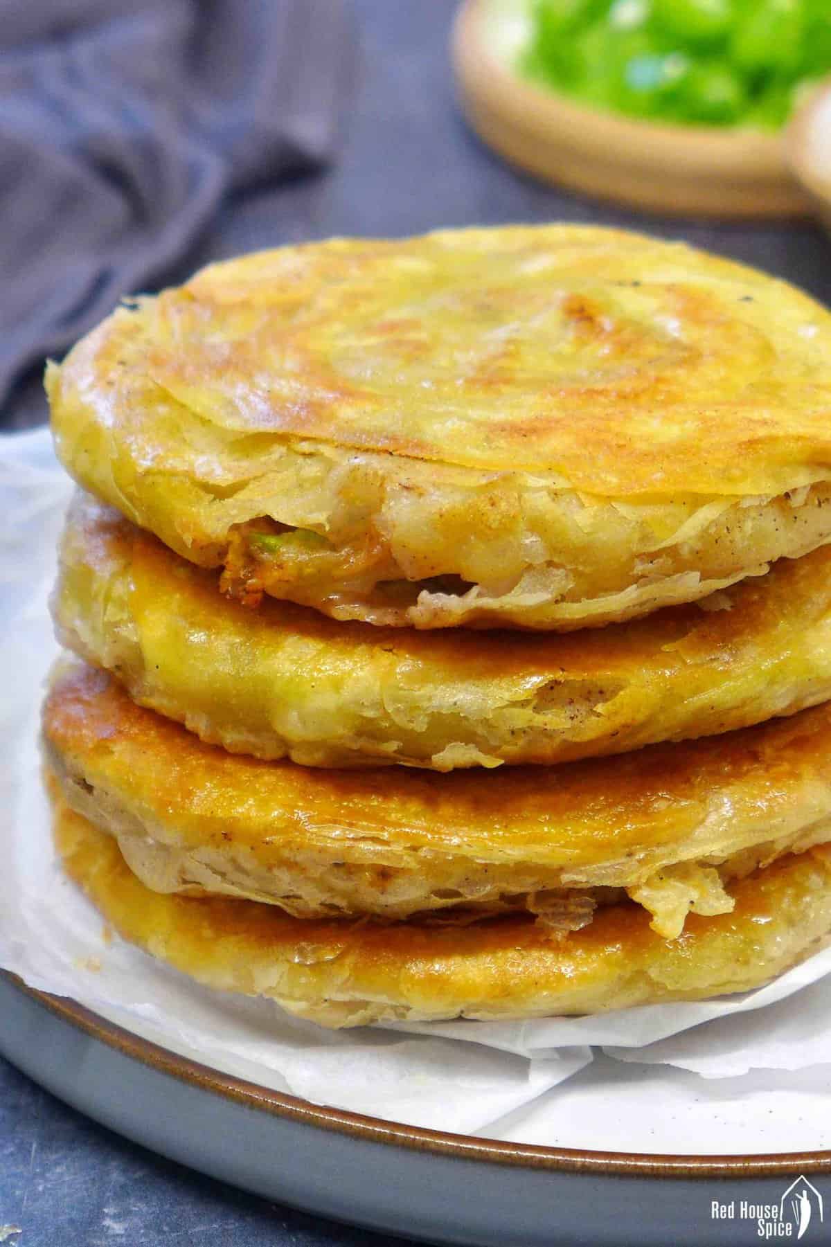 A stack of four pan-fried flatbread.