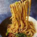 Dan Dan noodles lifted by chopsticks