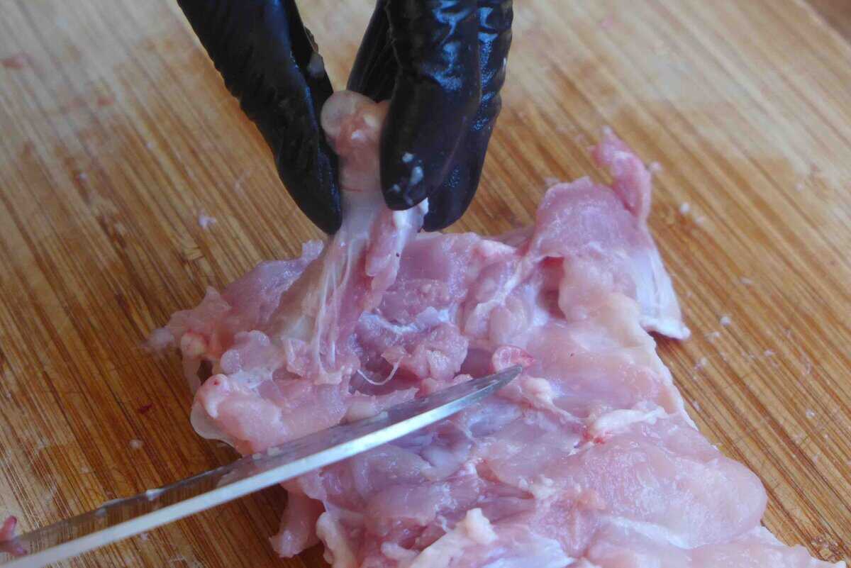 removing bone from chicken thigh.