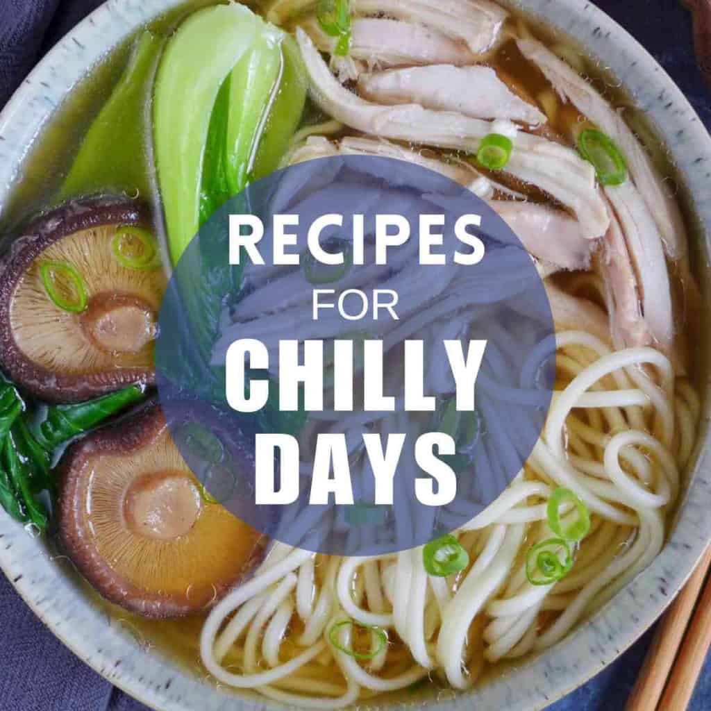 A bowl of chicken noodle soup with overlay text that says recipes for chilly days.