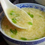 spooning egg drop soup.