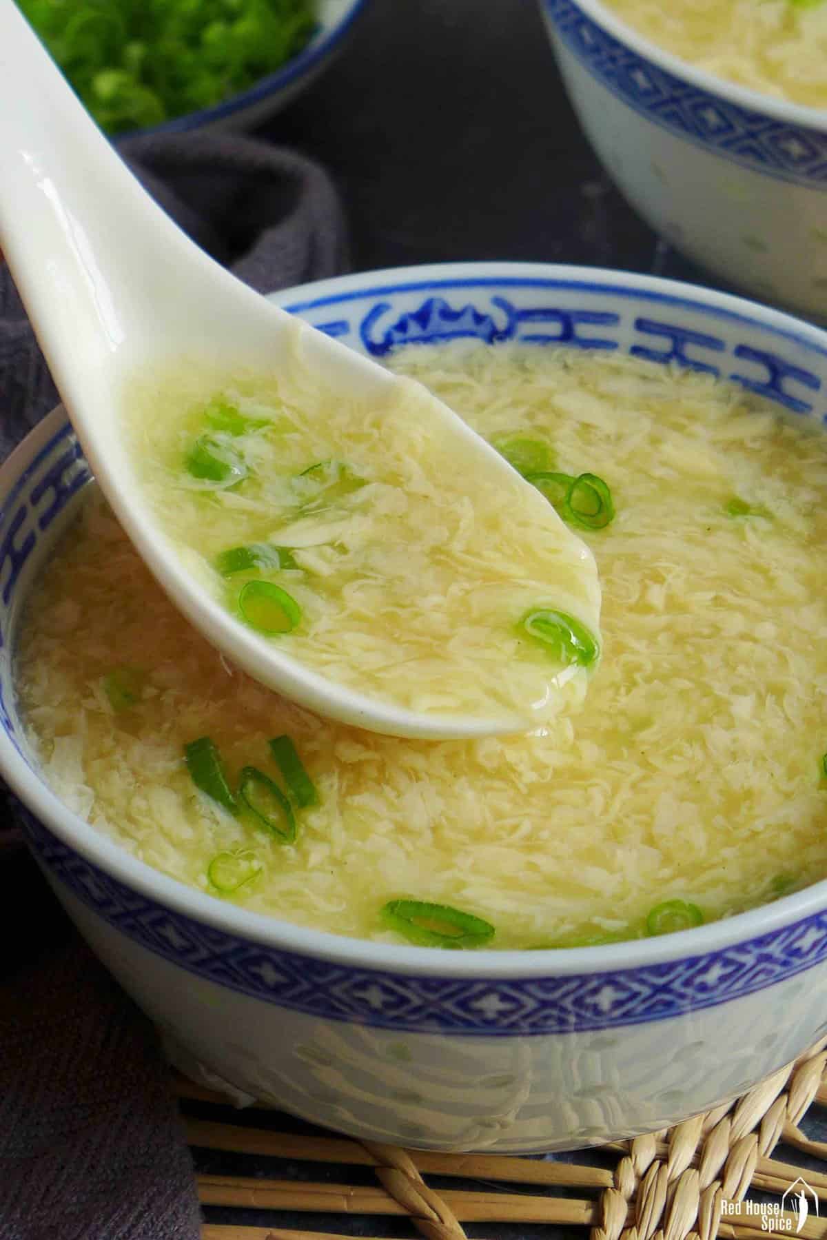spooning egg drop soup.