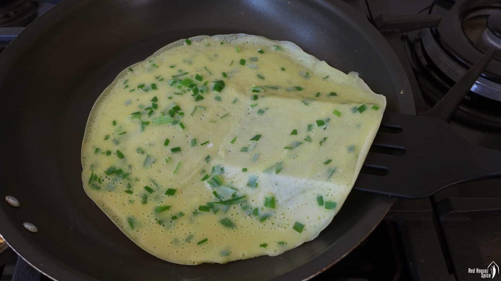 An egg crepe in a frying pan