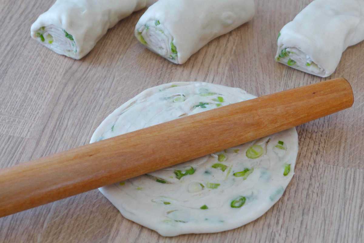 flatten a scallion pancake with a rolling pin