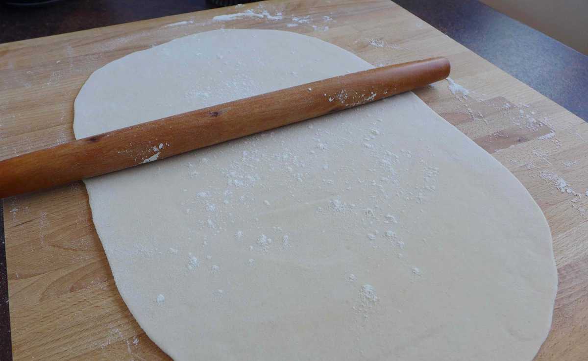 Flattening dough with a rolling pin