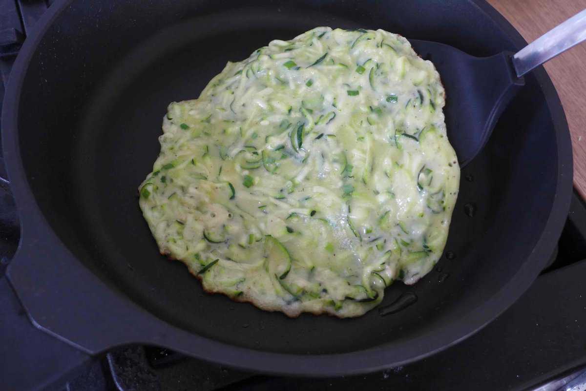 flipping a zucchini pancake.