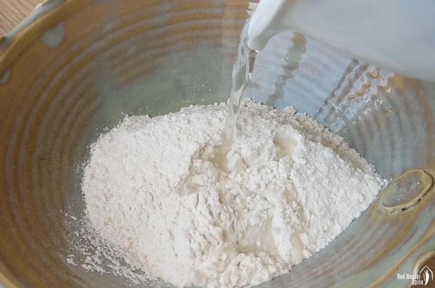 pouring water into flour