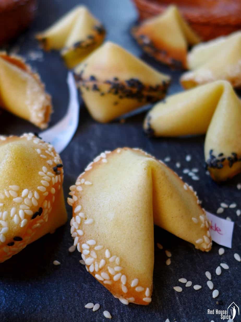 A close up shot of sesame rimmed fortune cookies.