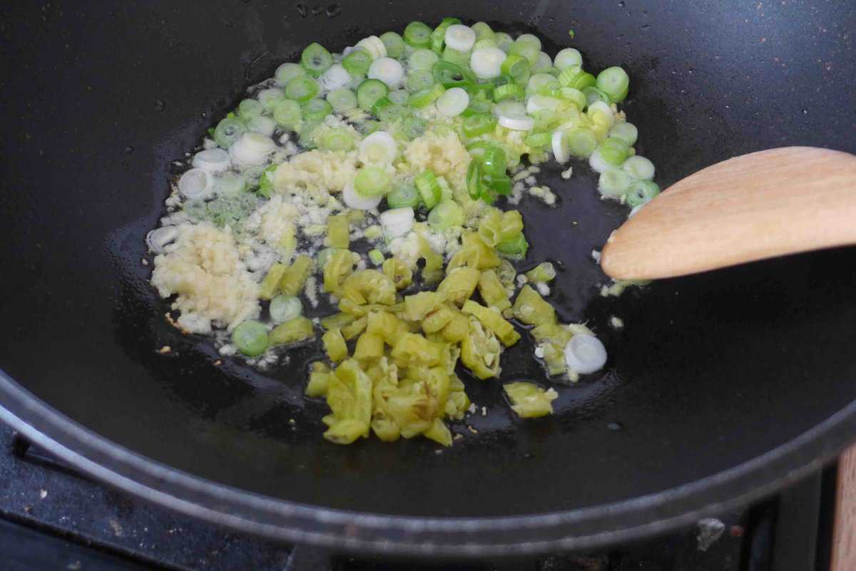 sizzling aromatics and pickled chili.