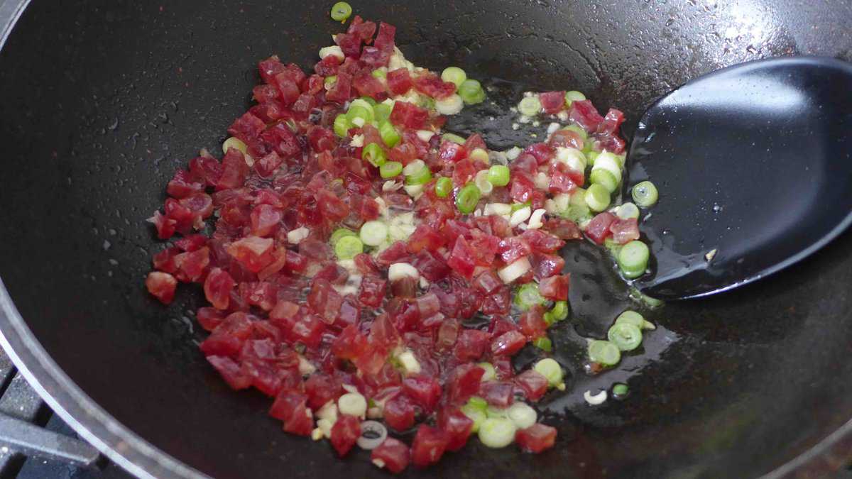 sizzling garlic, scallions, and Chinese sausages.