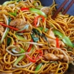 Stir-fried egg noodles with chicken and vegetables with overlay text that says chicken chow mein.