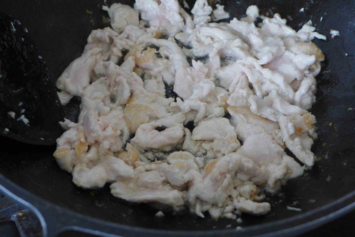 searing sliced chicken.