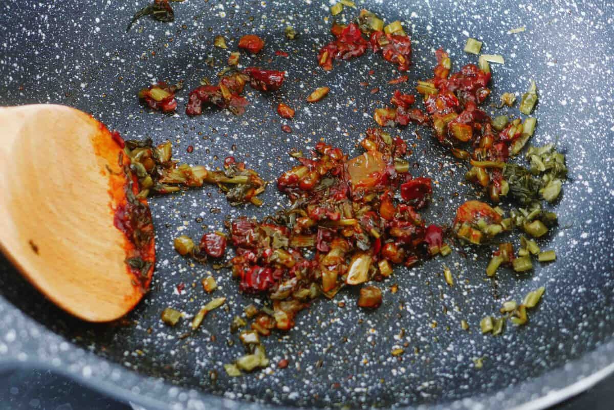 frying pickled mustard greens and sichuan chili bean paste.