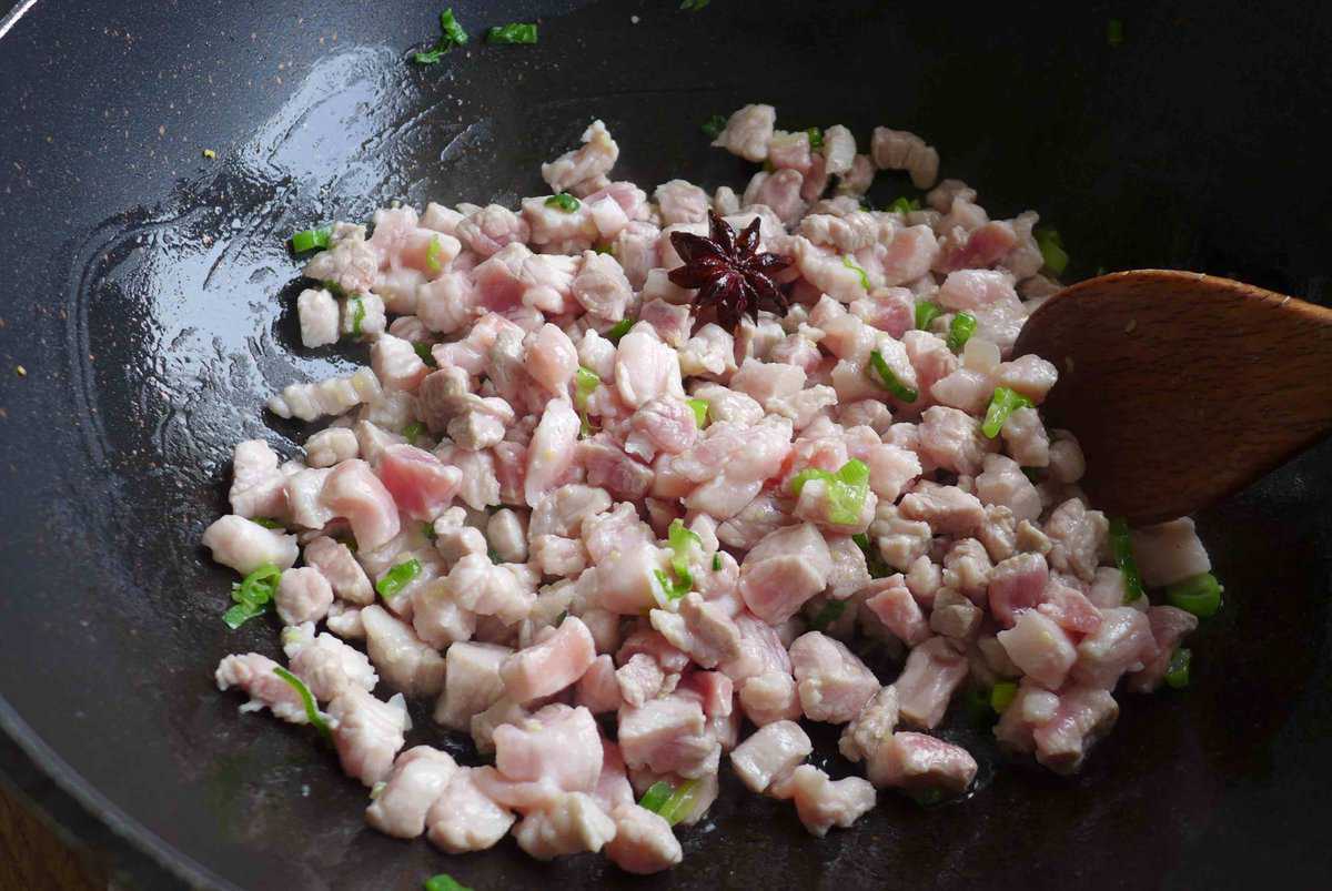 frying diced pork.