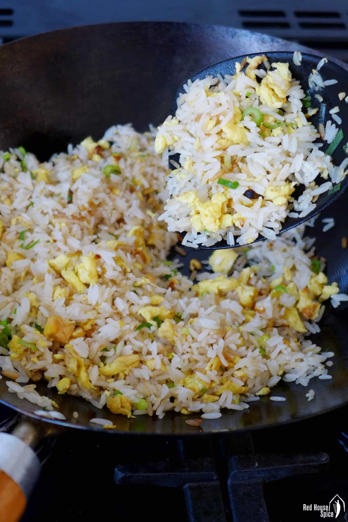 Frying egg and rice in a wok.