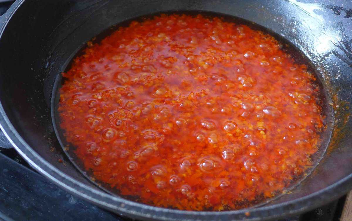 simmering garlic and fresh chili in hot oil.