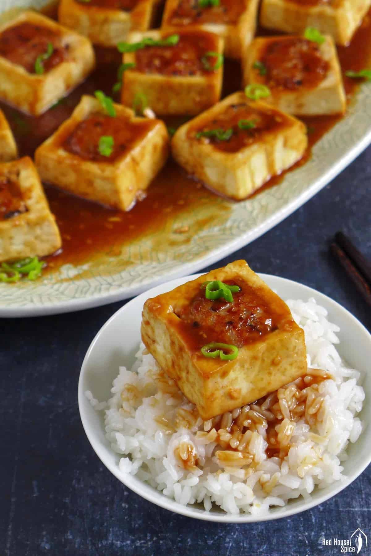 a piece of stuffed tofu over rice