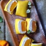 Pancakes filled with mango pieces and whipped cream
