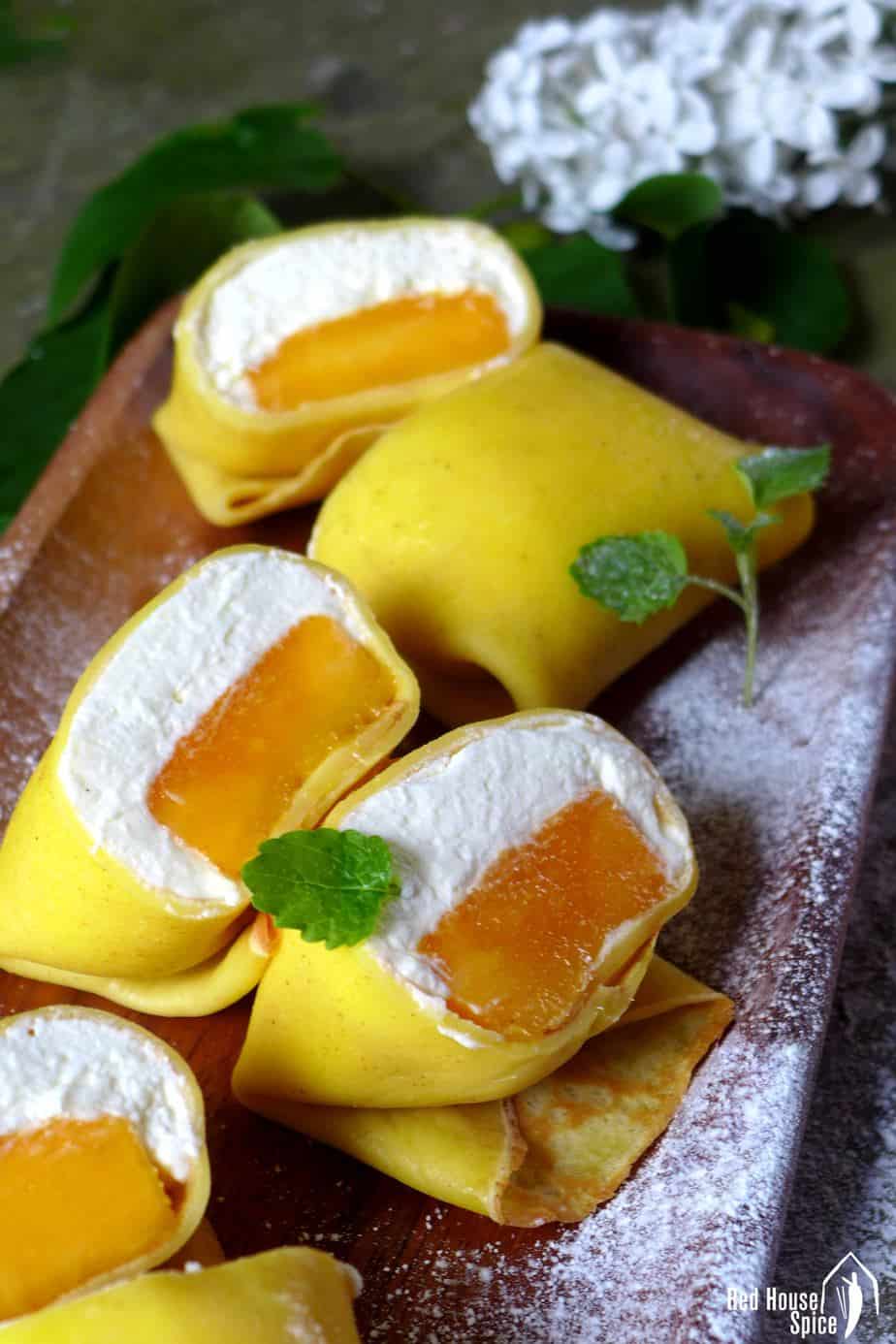 Fresh mango chunk topped with fluffy whipped cream, then wrapped with a thin, moist and elastic crepe, pillow-shaped mango pancake is a dessert to die for.