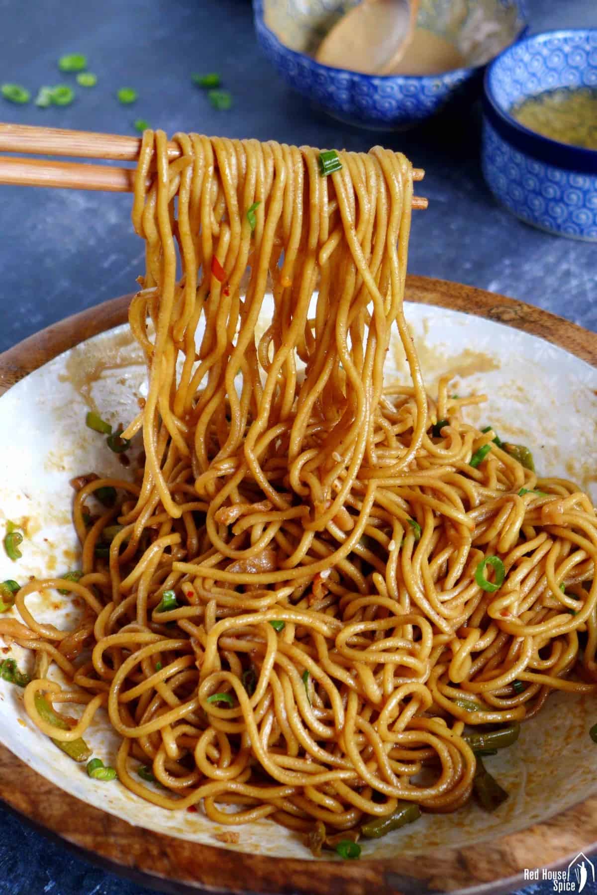 hot dry noodles lifted by chopsticks.
