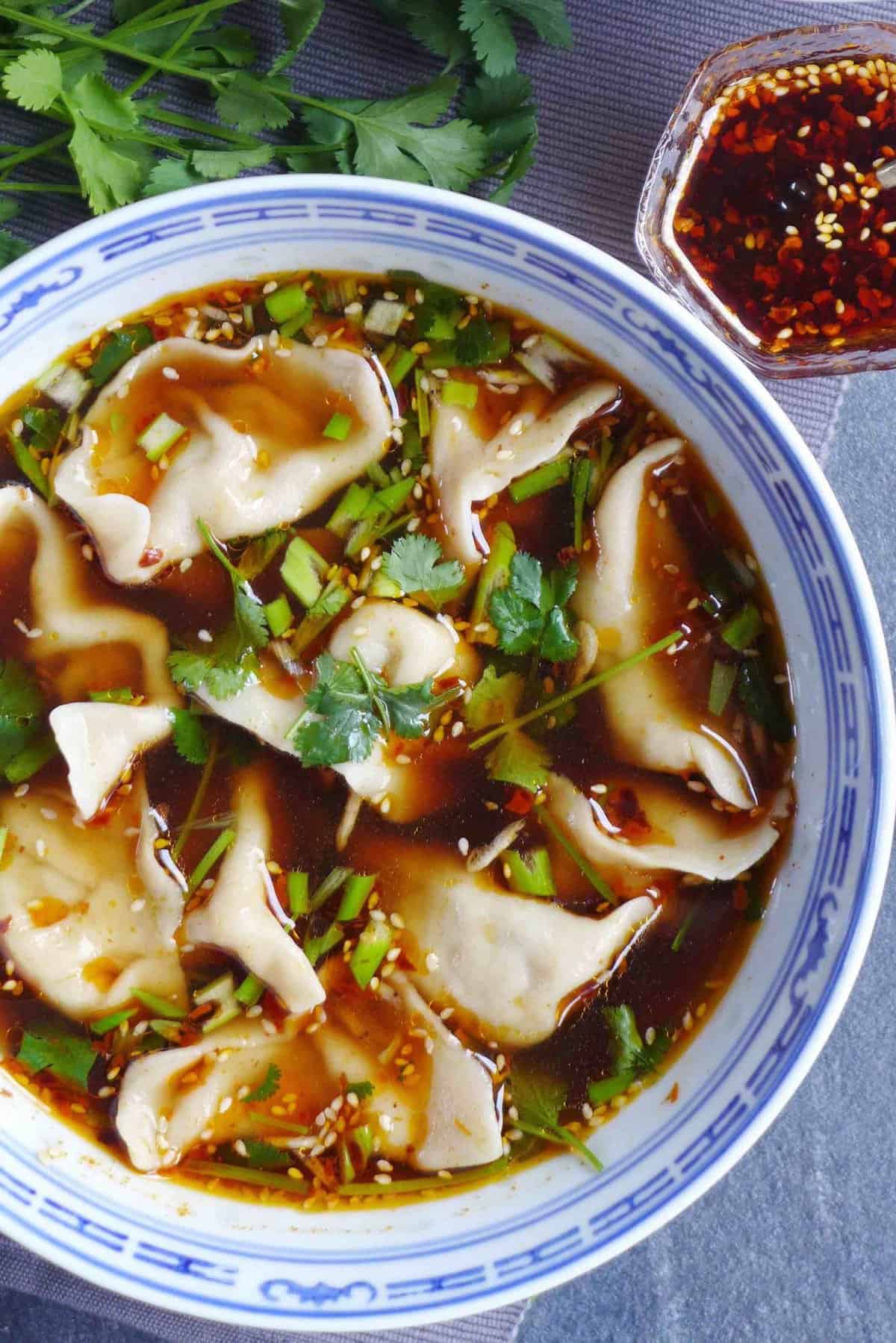 A bowl of hot and sour beef dumpling soup.