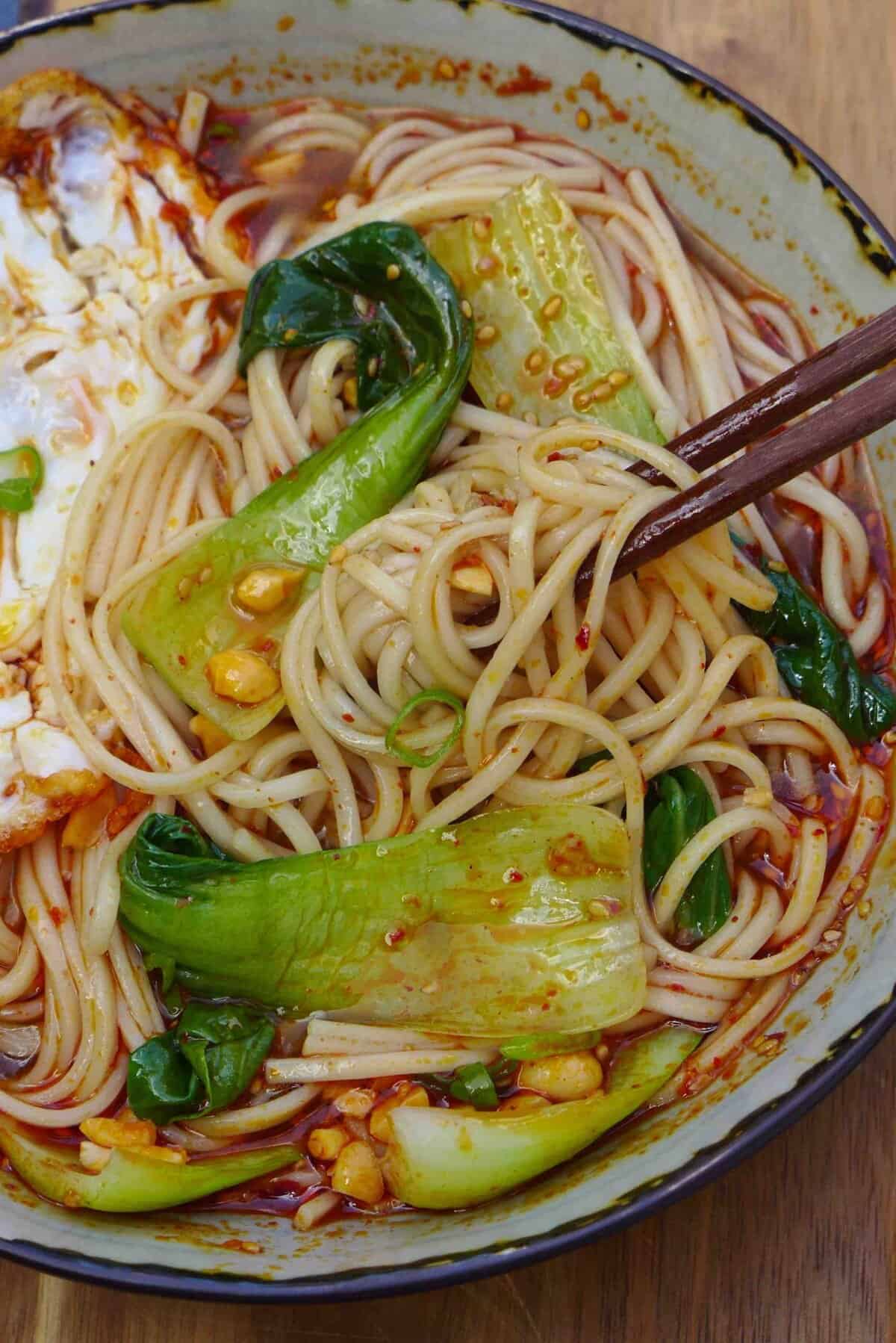 noodles picked up by chopsticks.
