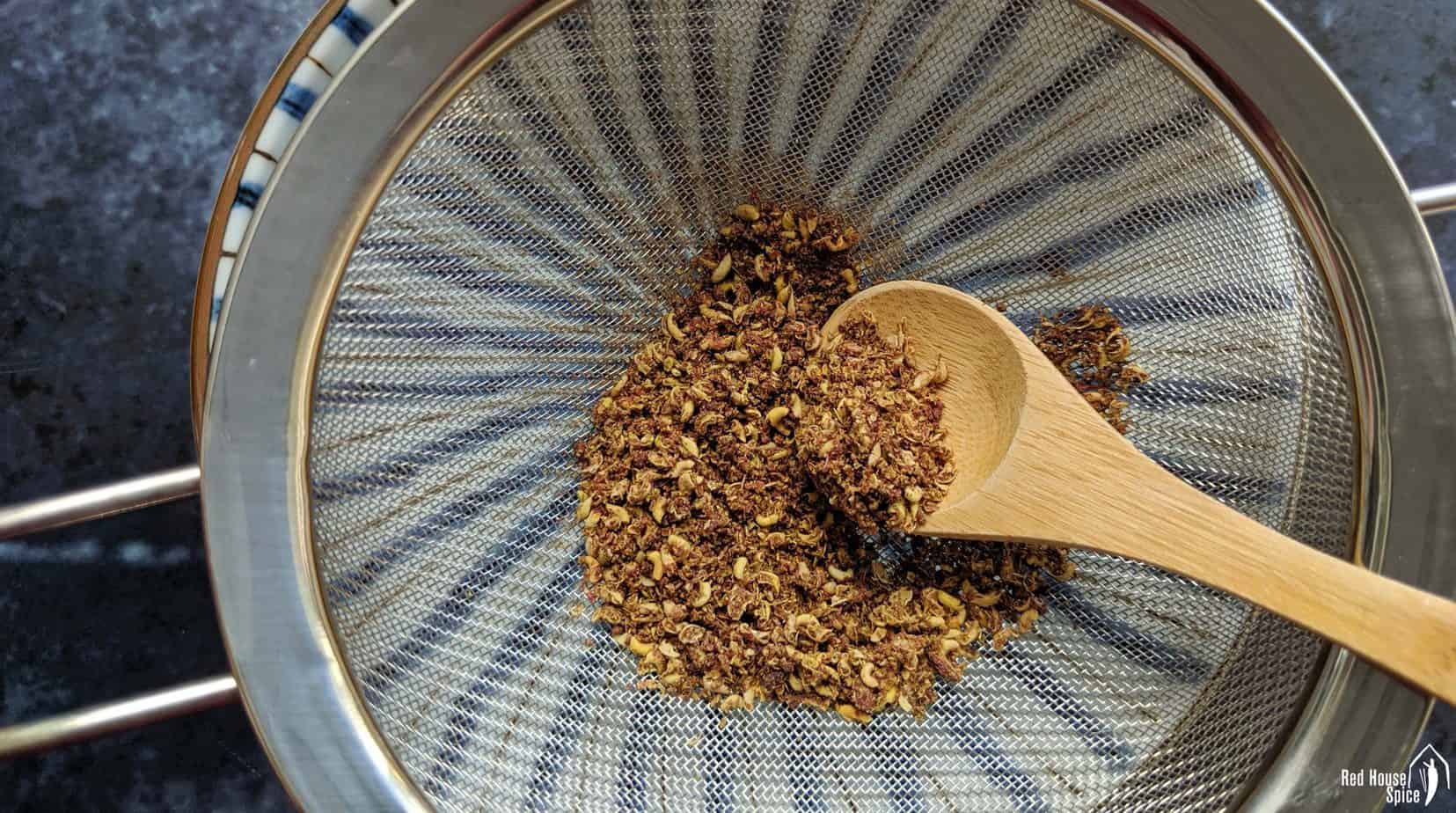 Crushed Sichuan pepper in a sieve