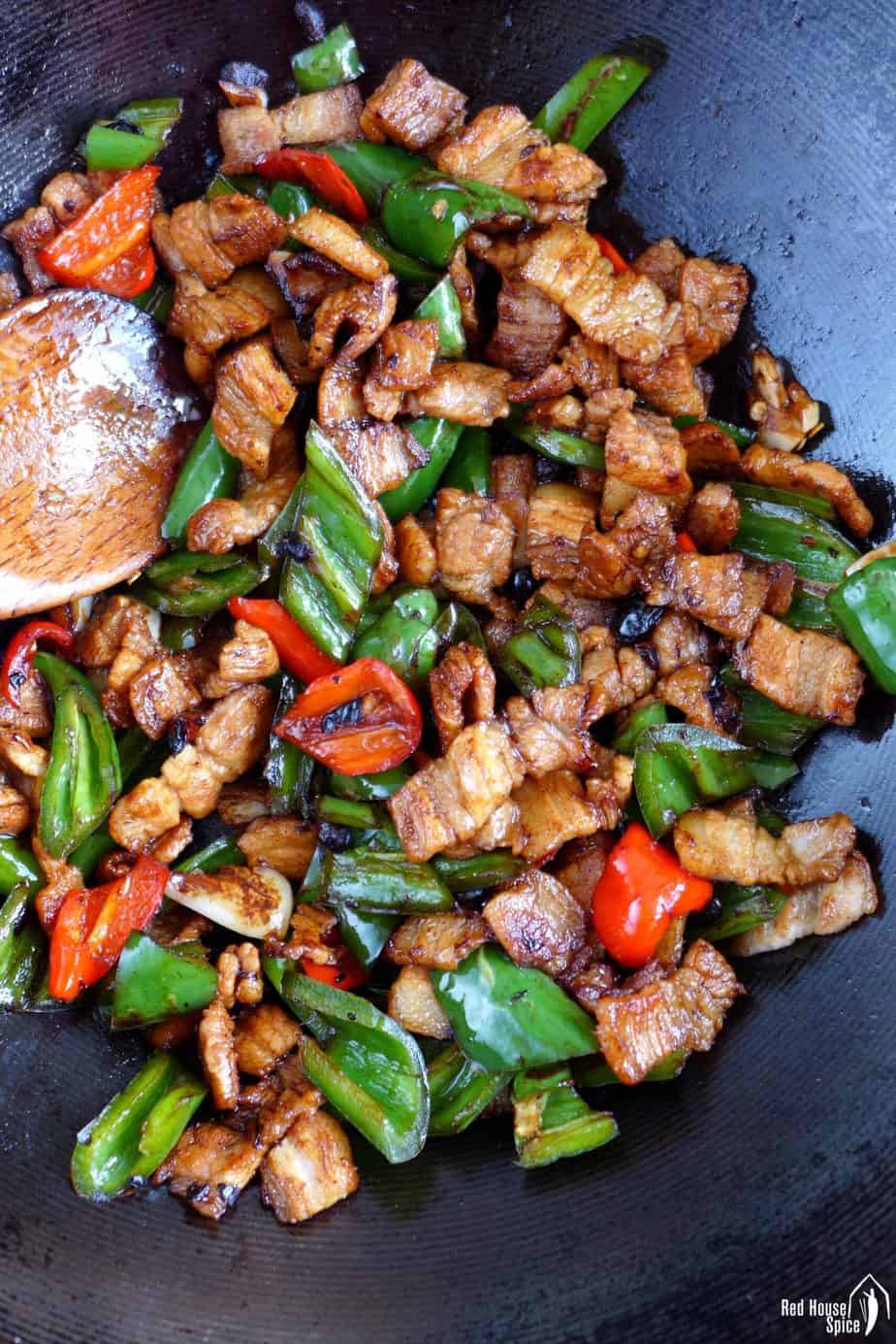 frying pork and chili in a wok
