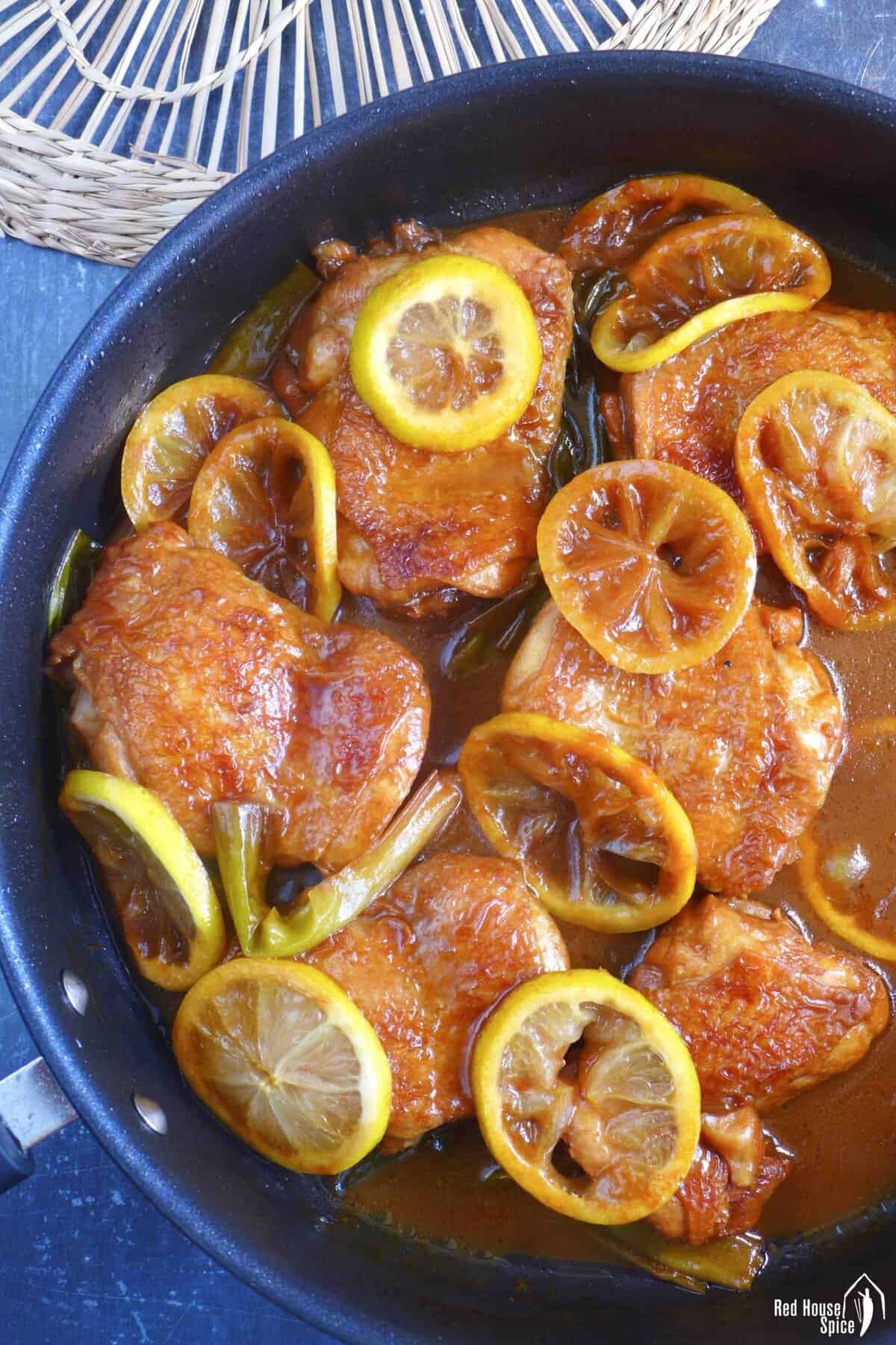 braised chicken with lemon in a skillet.