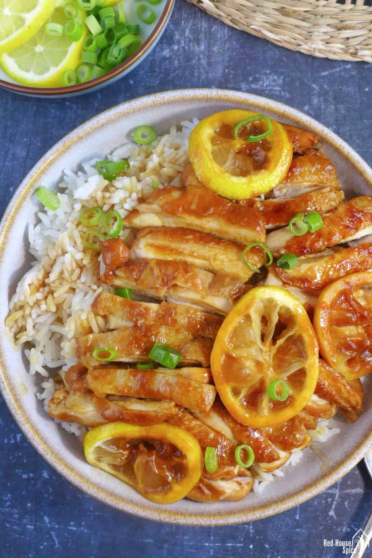 Chicken strips and lemon slices over rice.